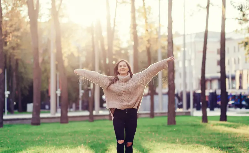 Woman enjoying sunny day in the park.